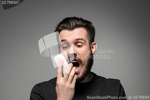 Image of Portrait of screaming man talking on the phone
