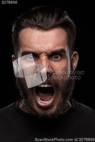 Image of Portrait of young screaming man in studio