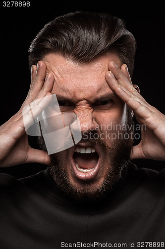 Image of Portrait of young screaming man in studio