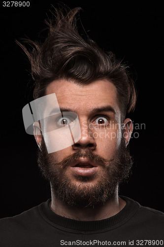 Image of Portrait of young tousled man in studio