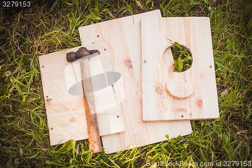 Image of Birdhouse parts with hammer  