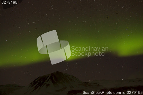 Image of Northern lights with snowy mountains in the foreground