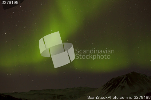 Image of Northern lights with snowy mountains in the foreground