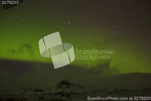 Image of Northern lights with snowy mountains in the foreground