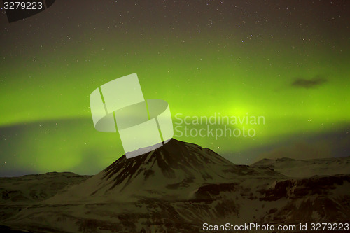 Image of Northern lights with snowy mountains in the foreground