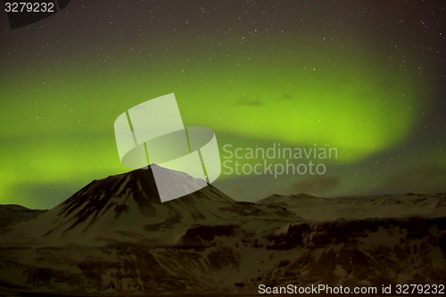 Image of Northern lights with snowy mountains in the foreground