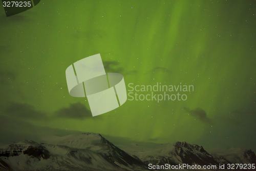 Image of Northern lights with snowy mountains in the foreground