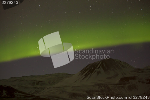 Image of Northern lights with snowy mountains in the foreground