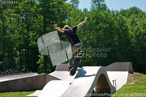 Image of Skateboarder Jumping Skate Ramp