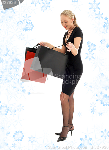 Image of euphoric shopping blond with snowflakes