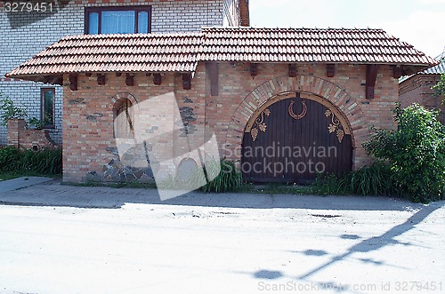 Image of building of red brick and wooden gates