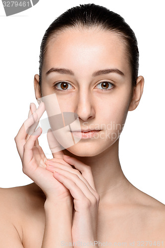 Image of Portrait of beautiful girl stroking her face with healthy skin 