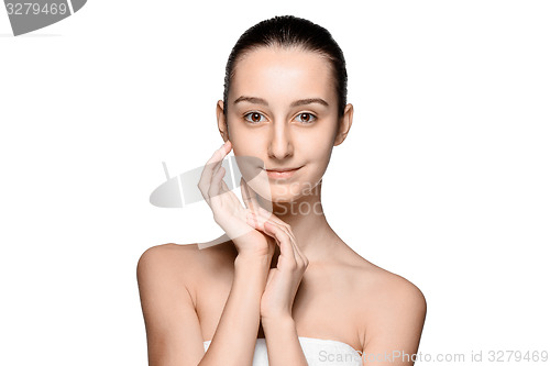 Image of Portrait of beautiful girl stroking her face with healthy skin 