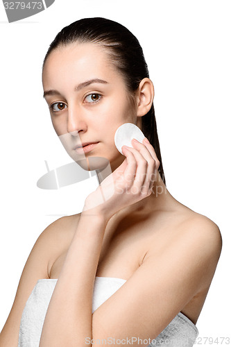 Image of skin care woman removing face with cotton swab pad
