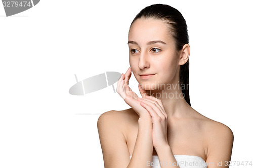 Image of Portrait of beautiful girl stroking her face with healthy skin 