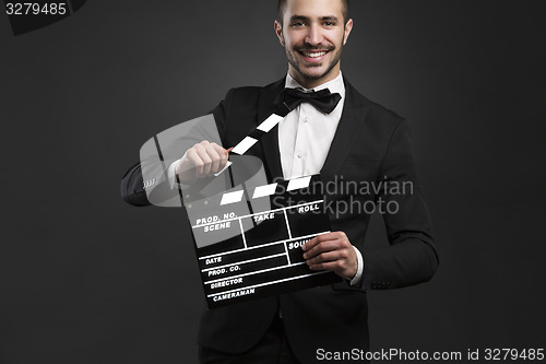 Image of Man holding a clapboard