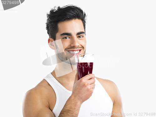 Image of Athletic man drinking a juice