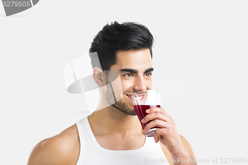 Image of Athletic man drinking a juice