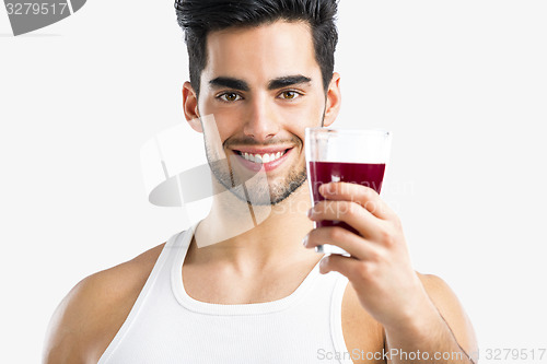 Image of Athletic man drinking a juice