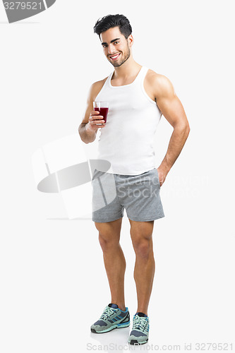 Image of Athletic man drinking a juice