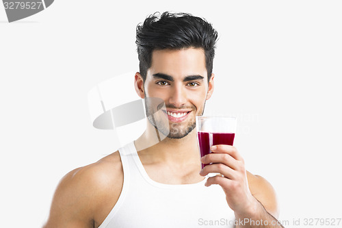 Image of Athletic man drinking a juice