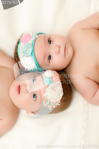 Image of Two twin babies, girls in nice headbands