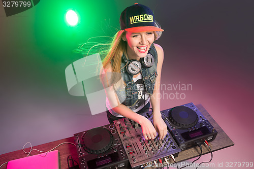 Image of Beautiful blonde DJ girl on decks - the party,