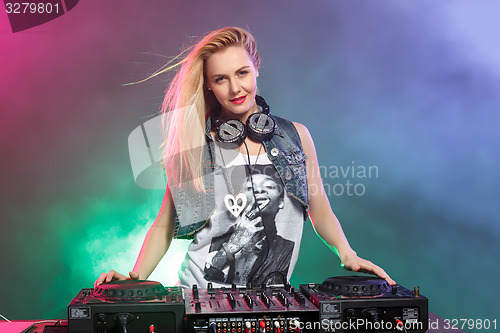 Image of Beautiful blonde DJ girl on decks - the party,