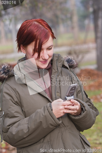 Image of Teen checking her mobile phone