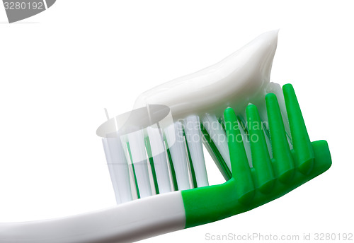 Image of Green toothbrush with toothpaste isolated on white background