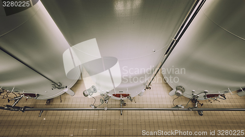 Image of Large industrial white silos in modern factory