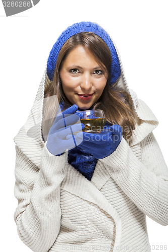 Image of Fashionable young woman sipping hot tea