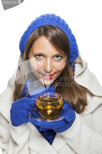 Image of Fashionable young woman sipping hot tea