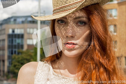 Image of Gorgeous Woman in Hat on Cloudy Sky background