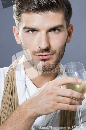 Image of Sexy handsome man drinking white wine