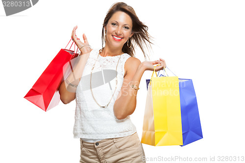 Image of Happy Woman Raising Colored Shopping Bag