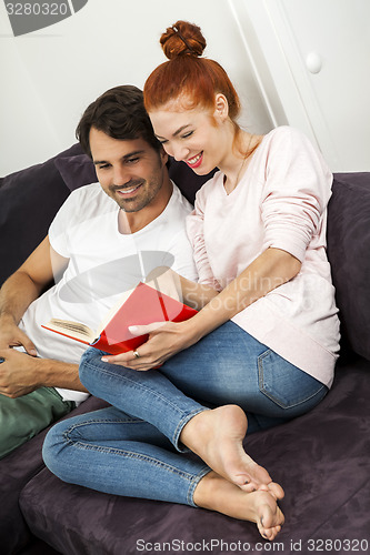 Image of Couple Resting on the Sofa at the Living Room