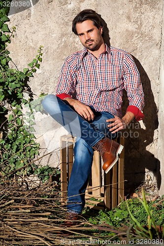 Image of Male model sitting with legs crossed