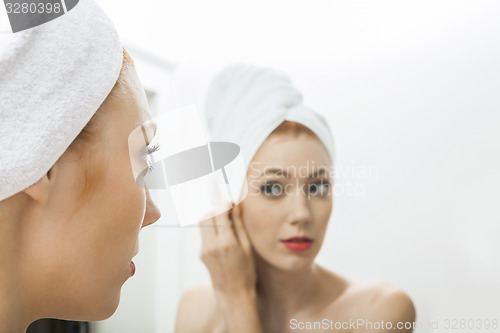 Image of Woman From Shower Looking her Face at the Mirror