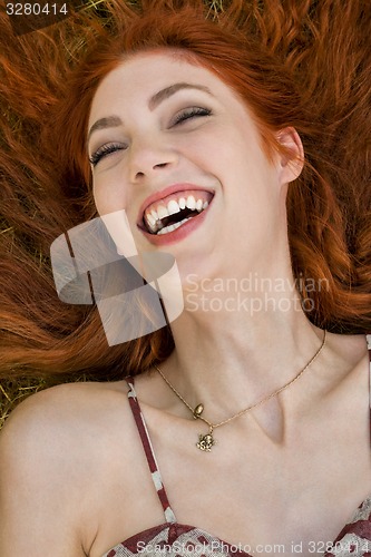 Image of Happy Woman Lying on Grassy Ground