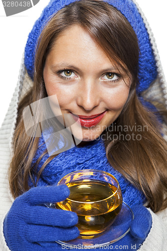 Image of Fashionable young woman sipping hot tea