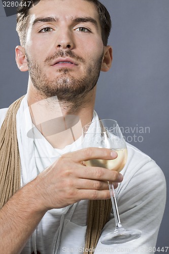 Image of Sexy handsome man drinking white wine