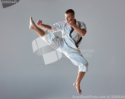 Image of Man in white kimono training karate