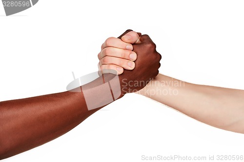 Image of Black and white human hands in a modern handshake 