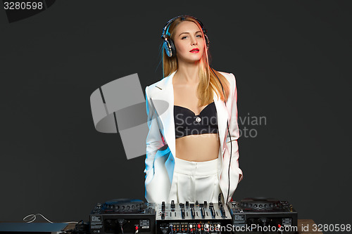 Image of Beautiful blonde DJ girl on decks - the party,