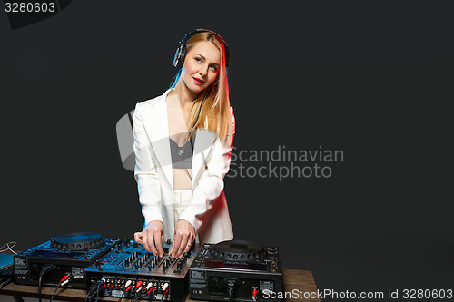 Image of Beautiful blonde DJ girl on decks - the party,