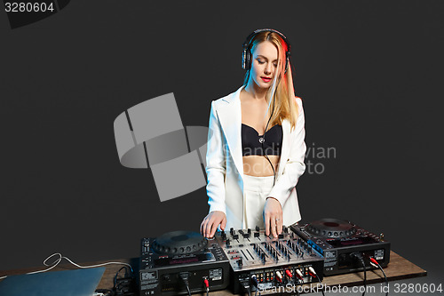 Image of Beautiful blonde DJ girl on decks - the party,