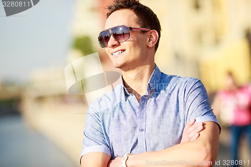 Image of Portrait of a handsome young man with sunglasses