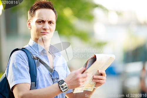 Image of Young man with map