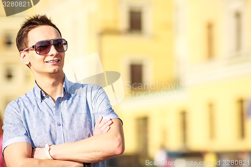 Image of Portrait of a handsome young man with sunglasses